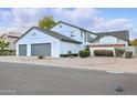 Beautiful home with a white exterior, large windows, and a well-maintained yard at 5742 W Shannon St, Chandler, AZ 85226