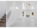 Bright living room with high ceilings, large windows, and a staircase at 5742 W Shannon St, Chandler, AZ 85226