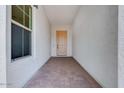 Inviting entryway with a decorative paver floor leading to a light wood front door at 5779 N 207Th Ave, Buckeye, AZ 85396
