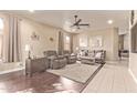 Comfortable living room featuring plush seating, a ceiling fan, and neutral decor at 6350 S Wilson Dr, Chandler, AZ 85249