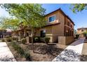 Charming tan two-story home with well-maintained landscaping and a welcoming walkway at 7726 E Baseline Rd # 134, Mesa, AZ 85209