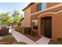 Inviting front entrance with a well-lit walkway leading to the stylish front door at 7726 E Baseline Rd # 134, Mesa, AZ 85209