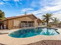 Backyard with a sparkling pool surrounded by a concrete patio and desert landscaping at 7726 W Cameron Dr, Peoria, AZ 85345