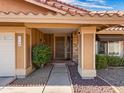 Inviting front porch with a walkway and desert landscaping at 7726 W Cameron Dr, Peoria, AZ 85345