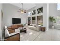 Bright living room with high ceilings, large windows, ceiling fan, neutral color palette and modern furniture at 913 W Juanita Ave, Gilbert, AZ 85233