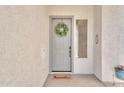 Inviting front entrance with wreath and 'home sweet home' door mat at 9626 W Bajada Rd, Peoria, AZ 85383