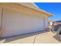 Close-up of the home's garage, featuring a well-maintained white door and clean concrete at 11816 S Winnebago St, Phoenix, AZ 85044