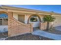 Inviting entryway with a brick facade, arched window, and well-manicured landscaping at 1257 W Dublin St, Chandler, AZ 85224