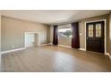 Spacious living room with wood-look floors and abundant natural light at 1257 W Dublin St, Chandler, AZ 85224