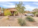 View of a single-story home featuring low-maintenance desert landscaping and a driveway with a parked car at 1409 E Mayfield Dr, San Tan Valley, AZ 85143