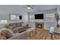 Bright living room featuring a cozy fireplace, TV, ceiling fan, and comfortable seating arrangement at 14145 N 92Nd St # 2046, Scottsdale, AZ 85260