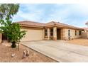 Charming single-story home featuring a low-maintenance front yard, two-car garage and covered porch at 1557 S Halsted Dr, Chandler, AZ 85286