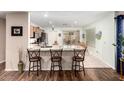 Bright, eat-in kitchen with granite countertops, stainless steel appliances, and breakfast bar seating at 1557 S Halsted Dr, Chandler, AZ 85286