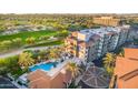 Stunning aerial view showcases community pool, golf course, and building exterior at 15802 N 71St St # 311, Scottsdale, AZ 85254