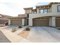 Exterior shot of townhome featuring attached garages and desert landscaping at 19700 N 76Th St # 1124, Scottsdale, AZ 85255