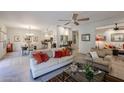 Bright open living room with comfortable seating, ceiling fan, and seamless flow to kitchen and dining at 19700 N 76Th St # 1124, Scottsdale, AZ 85255