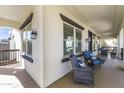 Relaxing front porch featuring comfortable seating, stylish windows, and charming decor at 20897 W Edith Way, Buckeye, AZ 85396