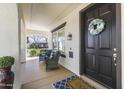 Cozy front porch with comfortable seating, stylish decorations, and a welcoming entrance at 20897 W Edith Way, Buckeye, AZ 85396