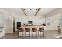 Modern kitchen boasts white cabinetry, granite countertops, and a central island with seating for casual dining at 22318 S 226Th Pl, Queen Creek, AZ 85142