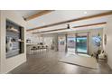 Spacious open-concept living area featuring wood beam ceilings and access to the backyard through sliding glass doors at 22318 S 226Th Pl, Queen Creek, AZ 85142