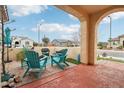 Covered patio featuring brick flooring and comfortable seating, perfect for outdoor relaxation and entertaining at 27467 W Osprey Dr, Buckeye, AZ 85396