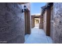 Close-up of exterior walkway with private entrance and stone facade detailing at 29120 N 22Nd Ave # 205, Phoenix, AZ 85085