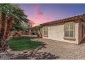 An inviting backyard with manicured lawn, mature trees, and a cozy fire pit at 3285 E Phelps St, Gilbert, AZ 85295
