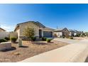 Lovely home featuring low maintenance landscaping, a two car garage, and a beautiful blue sky at 37783 W San Sisto Ave, Maricopa, AZ 85138