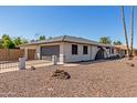 Charming single-story home with a two-car garage, a fenced yard, and desert landscaping at 3901 W Davidson Ln, Phoenix, AZ 85051