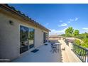 An attractive balcony featuring blue mats and a small round table set under a blue sky at 549 W Sweet Shrub Ave, Queen Creek, AZ 85140