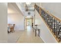 Bright foyer featuring decorative tile flooring, staircase with wrought iron railing, and natural light at 549 W Sweet Shrub Ave, Queen Creek, AZ 85140