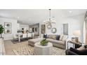 Bright, airy living space featuring a modern sectional, decorative rug, and stylish pendant lighting at 5771 E Axle Ln, San Tan Valley, AZ 85140