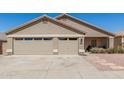 Charming single-story home featuring a three-car garage and well-maintained desert landscaping at 6526 W West Wind Dr, Glendale, AZ 85310