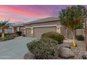 Home exterior showcasing xeriscaping, decorative rock and mature trees at twilight at 6751 S Callaway Dr, Chandler, AZ 85249