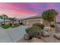 A desert home featuring manicured landscaping, decorative rock, shrubs and mature trees at 6751 S Callaway Dr, Chandler, AZ 85249