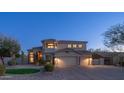 Well-maintained home exterior with a three-car garage and mature landscaping at 6929 E Trailridge Cir, Mesa, AZ 85207