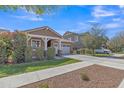 Charming single-Gathering home with a well-manicured lawn, neutral paint, and a two-car garage at 7115 E Olla Ave, Mesa, AZ 85212