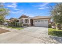 Charming one-story home featuring a two-car garage, covered entry, and well-maintained front yard at 7115 E Olla Ave, Mesa, AZ 85212