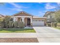 Inviting one-story home with a two-car garage, neutral paint, covered entry, and fresh landscaping at 7115 E Olla Ave, Mesa, AZ 85212