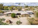 This home features unique landscaping, with a mix of desert plants and an old rusty car placed as art at 7131 E Cholla St, Scottsdale, AZ 85254