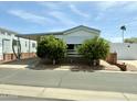 Charming single-story home with carport and mature trees adding curb appeal at 7750 E Broadway Rd # 433, Mesa, AZ 85208