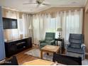 Comfortable living room with plush armchairs, natural light and modern entertainment center at 7750 E Broadway Rd # 433, Mesa, AZ 85208