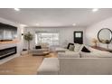 Cozy living room showcasing a plush sectional sofa, electric fireplace, and stylish decor at 7811 N 32Nd Ave, Phoenix, AZ 85051