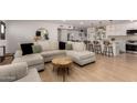 Bright and airy living room featuring a large sectional sofa and seamless flow to the kitchen at 7811 N 32Nd Ave, Phoenix, AZ 85051