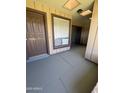 Exterior view of the front door with a window and sidelight on a covered porch at 8101 N 107Th Ave # 26, Peoria, AZ 85345