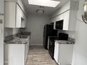 A well-lit kitchen showcases granite countertops, stainless steel sink, and black appliances at 8101 N 107Th Ave # 26, Peoria, AZ 85345