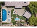 Beautiful backyard featuring a sparkling pool with water features, jacuzzi, fire pit, and covered patio at 8260 W Cielo Grande Ave, Peoria, AZ 85383