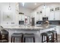 Bright and airy kitchen featuring granite countertops, stainless steel appliances, and white cabinets at 8260 W Cielo Grande Ave, Peoria, AZ 85383