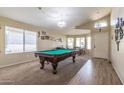Spacious game room with a pool table, carpet, and a transition to wood flooring near the front door at 85 W Grey Stone St, San Tan Valley, AZ 85143