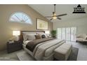 Bright bedroom featuring a ceiling fan, large window, and neutral color palette at 9130 W Rimrock Dr, Peoria, AZ 85382